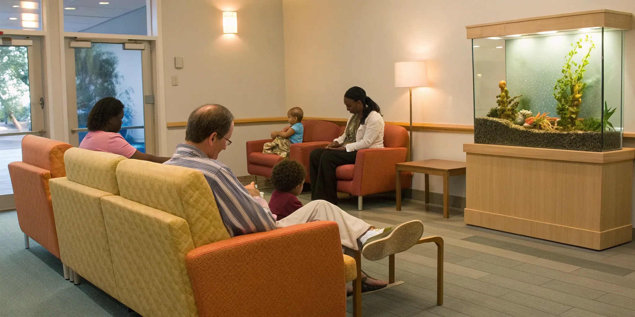 A family feeling comfortable in the waiting room of their Harlem dental clinic.